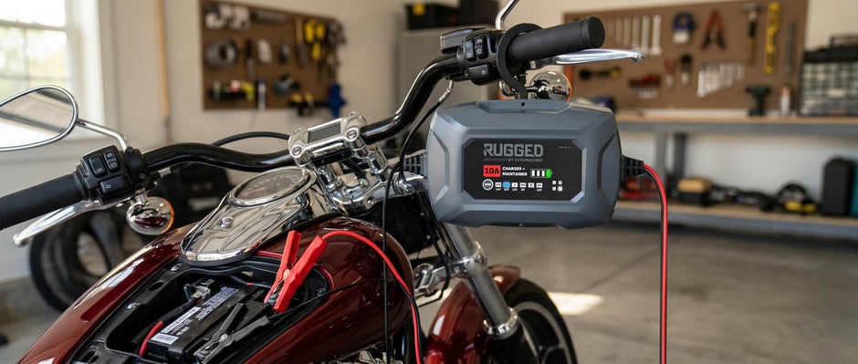 Schumacher Rugged Energy motorcycle battery charger connected to a motorcycle battery in a garage
