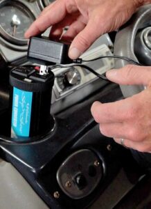 Close up of a man using a power converter in a car